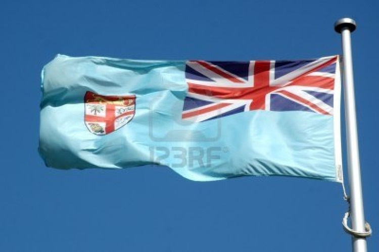 15278951-the-flag-of-fiji-against-blue-sky